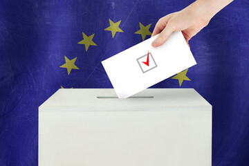 European Union Vote concept. Voter hand holding ballot paper for election vote on polling station