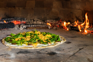 Preparing homemade spinach pizza with mushrooms. Vegetarian pizza. Home baking. Healthy food. Traditional Italian food.