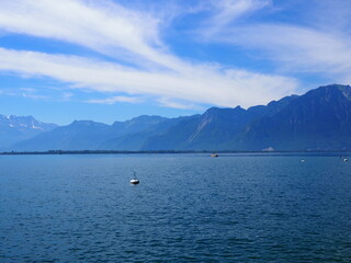 Landscapes of Lake Geneva in european Montreux city in canton Vaud in Switzerland, cloudy blue sky in 2017 warm sunny summer day on July.