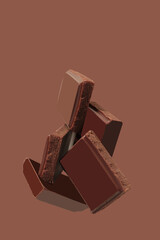 Delicious black chocolate shavings and pieces on  background, top view