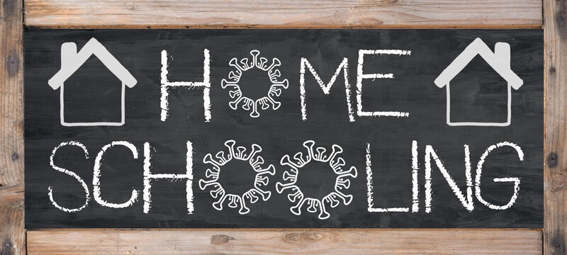HOMESCHOOLING - Old rustic blackboard with wooden frame, white lettering and copy space
