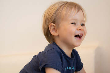 Beautiful blond baby boy very happy and smiling