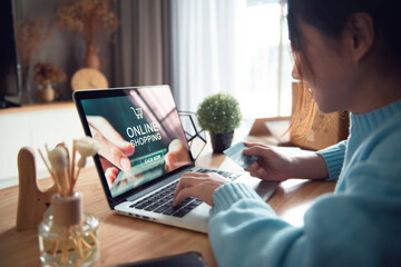 E-commerce and online shopping concept, Woman hand using laptop (Mockup website) and holding credit...