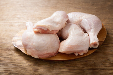 fresh chicken legs on a wooden table