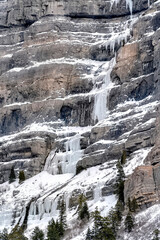 Naklejka na ściany i meble Bridal Veil Falls with frozen water on steep slope during winter in Provo Canyon