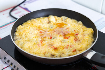 Omelette in frying pan on an induction cooker