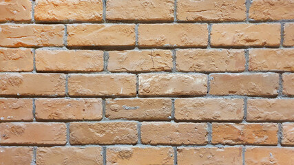 close up of old brick wall, old texture of orange stone blocks.