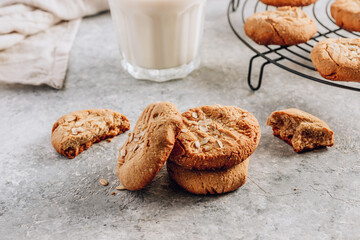 Gluten free homemade oatmeal cookies and oat milk on a light background.