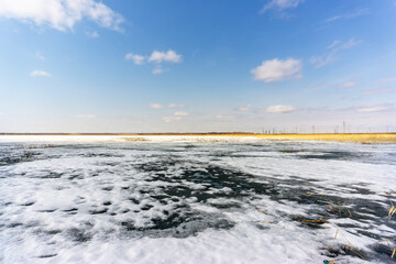 water melts on the winter lake snow, the beginning of spring Siberia