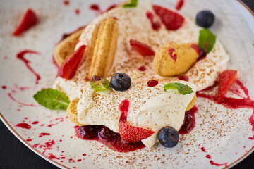 Gentle soft tiramisu. Cookies with mascarpone cream and fresh fruit.