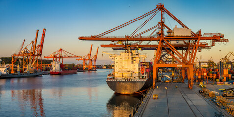 Container port in the rays of the setting sun. Gdynia, Poland - obrazy, fototapety, plakaty