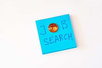 Looking for a job concept - Blue notebook with job search phrase. Five cent coin. Flat lay white background
