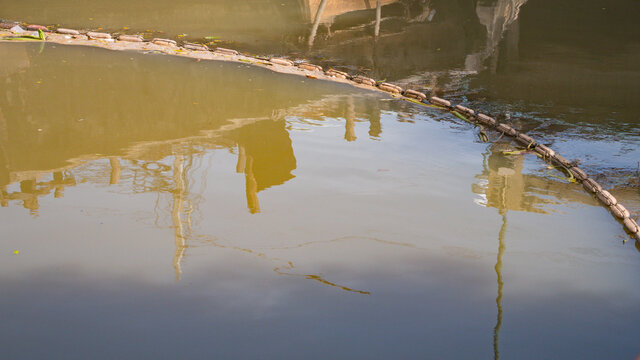 buoy entrap garbage  in canal , prevent  wastrel float to the sea