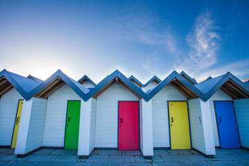 Fototapeta na wymiar Beach huts and blue skies