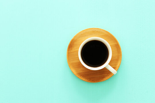 Top view image of coffe cup on mint pastel background. Flat lay. Copy space