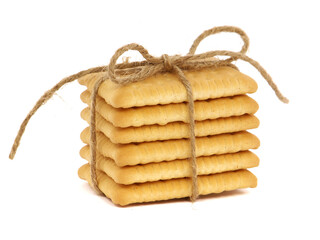 Stack of butter biscuits, tied with rope, isolated on white 