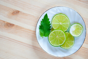 Flat lay: lime, mint on an old wooden table,  a refreshing drink in the hot summer. Cooling, pleasant taste. Ingredients, homemade recipe