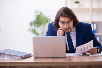 Young male employee unhappy with excessive work