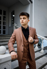 Portrait of a handsome sexy man outdoors in the city. Luxurious lifestyle. Fashion removed. Men's clothing and accessories.