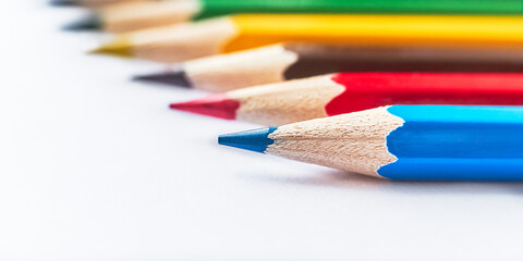 Colored pencils. Blue, red, brown, yellow, green pencils collected in group. Macro Selective focus