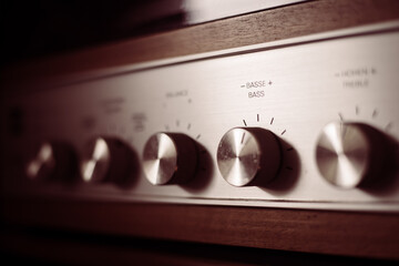 Silver wooden vintage amplifier: Close up of control knobs - obrazy, fototapety, plakaty