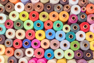 Threads in a tailor textile fabric: colorful cotton threads, birds eye perspective