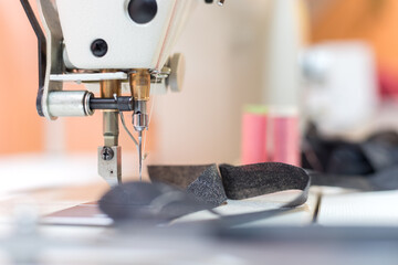 Sewing in a tailor workshop: Close up picture of sewing needle
