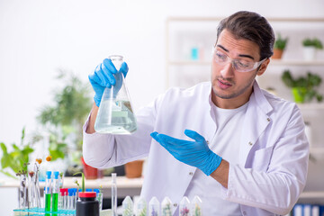 Young male chemist working in the lab