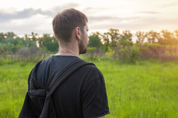 Rear view of a traveler looking at nature in the forest. Tourism, outdoor activities concept. Lifestyle.