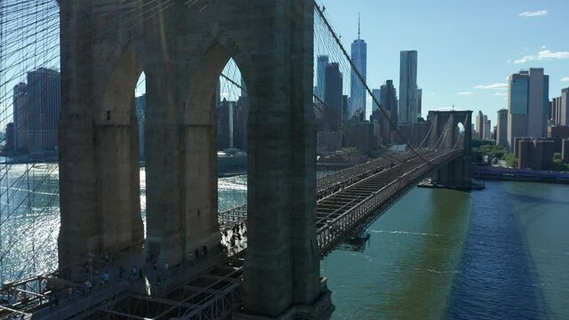 another flying backward view of BLM marchers streaming across Brooklyn Bridge towards NYC