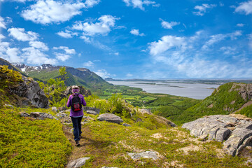 Happy woman on hike to the Skogmo mountain in great summer weather, Nordland county
