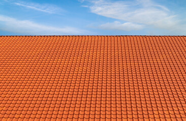 Terracotta roofing tile pattern blue sky white clouds background