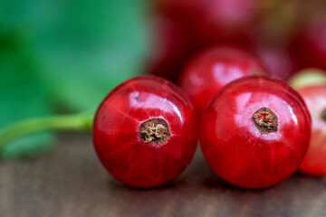 Red cur5rants in close up, wooden table