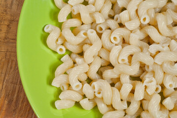 Vermicelli in a green plate on a wooden table. Food close up on an old shabby blackboard.
