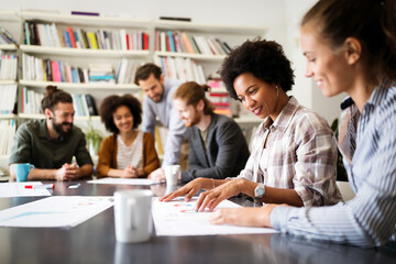 Fototapeta premium Cheerful coworkers in office during company meeting