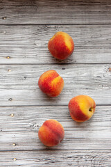 peaches on a light wooden background, flat fly