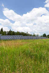 Solar Power Station on the spring flowering Meadow 