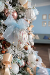 Pastel colored decoration for christmas.Decorative christmas tree, golden candlestick, bauble and gold garland on pink knitted background. New Year or Christmas concept. postcard, invitation.