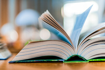 Open book lying on the table in the library