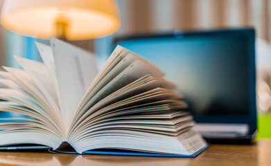 Open book lying on the table in the library