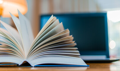 Open book lying on the table in the library