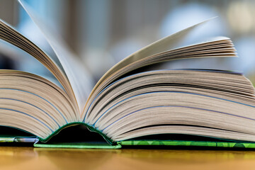 Open book lying on the table in the library