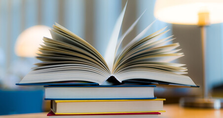 Open book lying on the table in the library