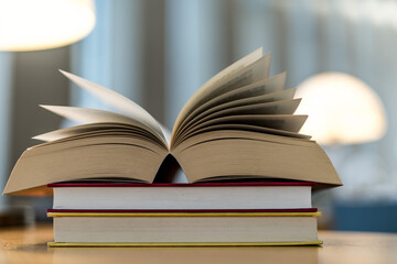 Open book lying on the table in the library