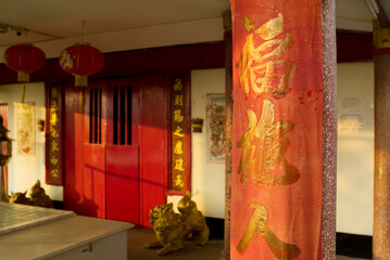 traditional chinese lanterns, red door and golden
calligraphy in a temple in Vientiane, Laos
