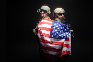American special forces. two rangers in uniform with weapons stand together against a dark...