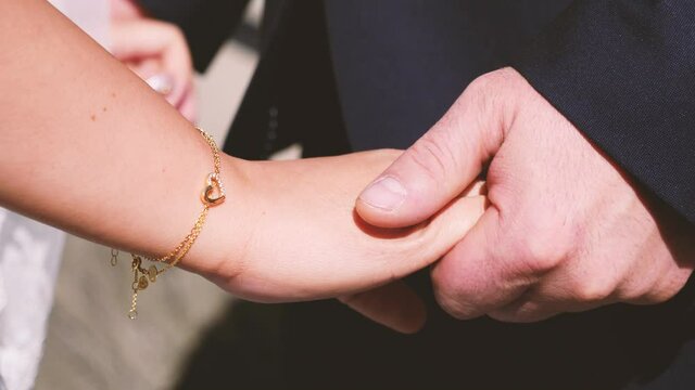 bride and groom holding hands