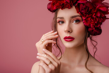 Beauty portrait of young beautiful woman with red color eyes, lips makeup, wearing pearl trendy...