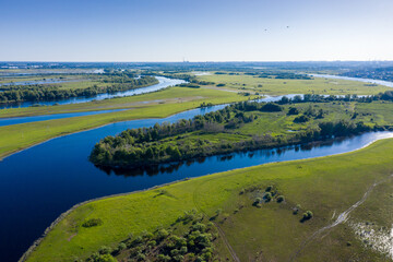 Fototapeta na wymiar Scenic aerial view of a river and green fields in a countryside