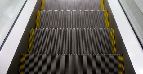 An empty escalator in the metro. A means of transportation in a modern city. Safe descent.